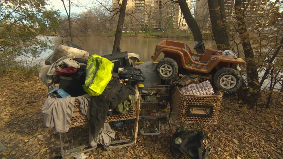 homeless-camp-by-river-garbage.webp