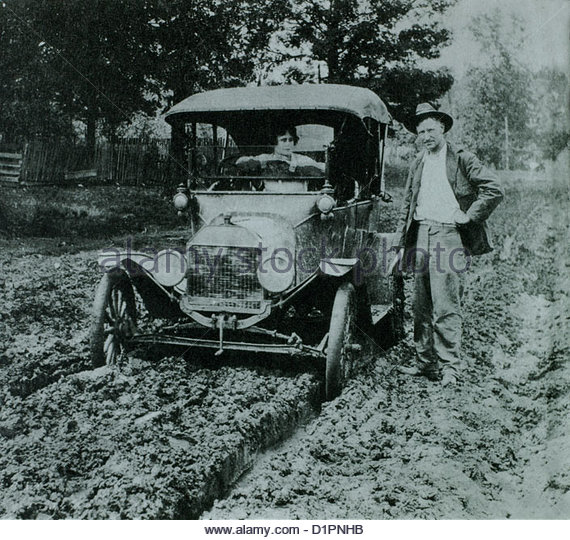 woman-in-ford-model-t-car-on-muddy-road-with-man-standing-next-to-d1pnhb.jpg
