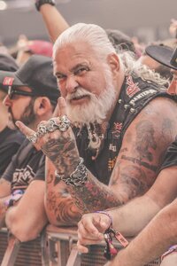 expressive-old-metalhead-makes-horns-expressive-old-metalhead-many-tattoes-long-hairs-rings-ma...jpg